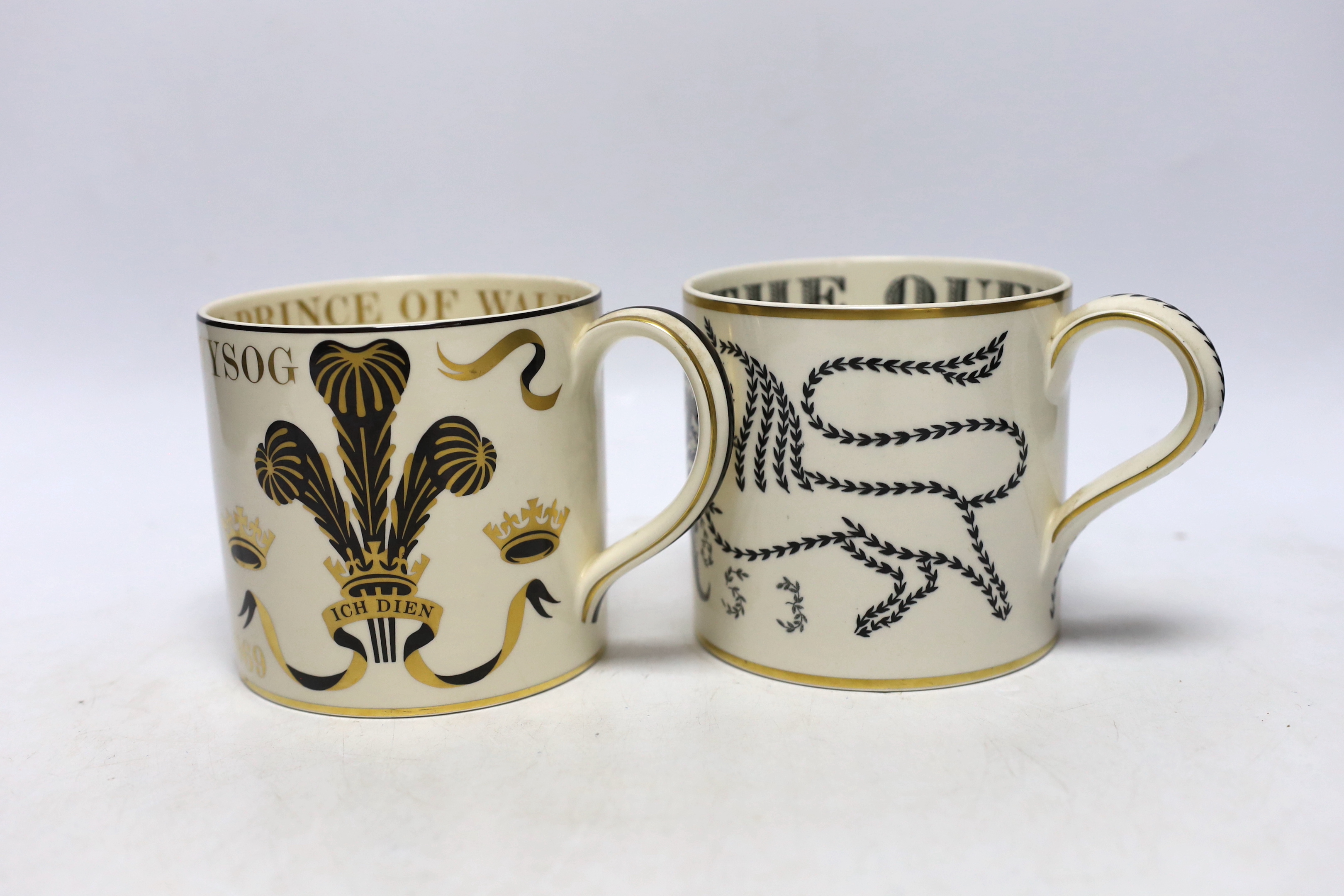 Two Wedgwood commemorative mugs by Guyatt; the Investiture of the Prince of Wales and the Coronation of Queen Elizabeth II